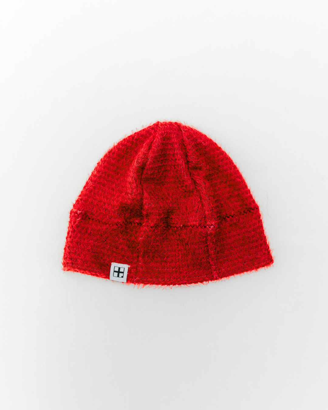 Red knit beanie on a white background