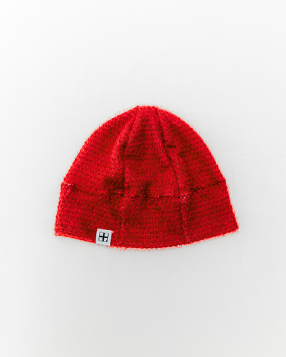 Red knit beanie on a white background